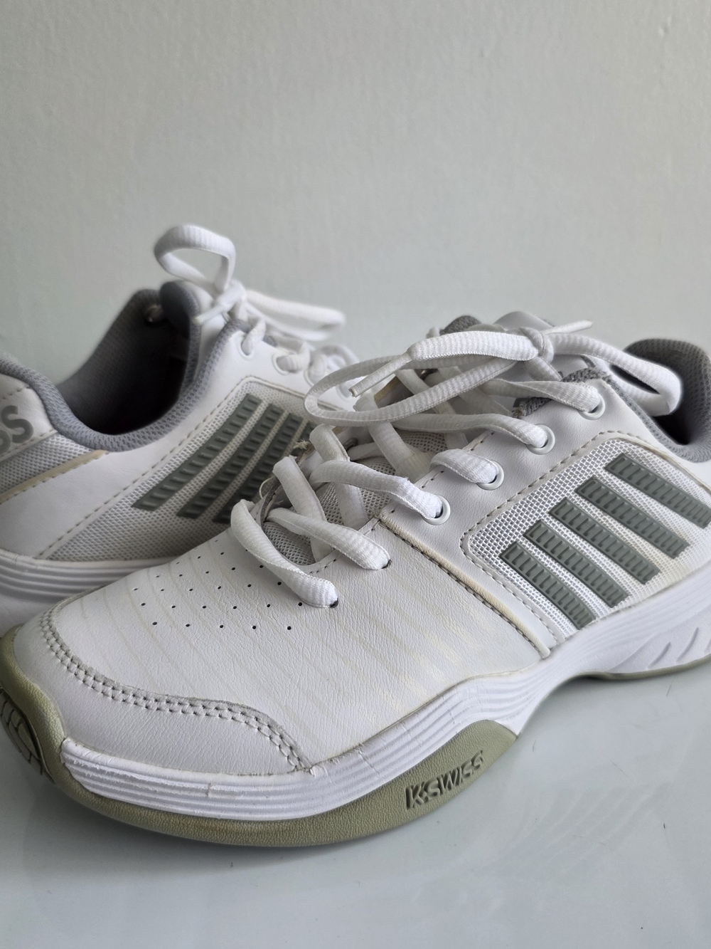 K-Swiss White Sneakers with Light Gray Stripes.